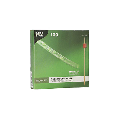 The green box "PAPSTAR 100 Fingerfood - Picker" by PAPSTAR GmbH contains 100 bamboo picks each 9 cm long. The bio-based packaging shows a pick with a red tip, ideal for serving finger food skewers at any event.