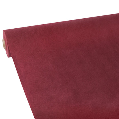 A partially unrolled Starpak tablecloth, fabric-like, fleece 'Soft Selection' in deep red is depicted diagonally on a white background.