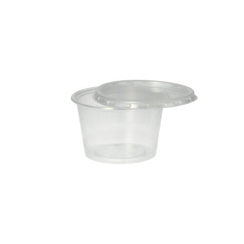 A Starpak 50 dressing cup, PP, round, Ø 7.1 cm, transparent, stands empty against a plain white background, with the matching clear plastic lid partially open on it.