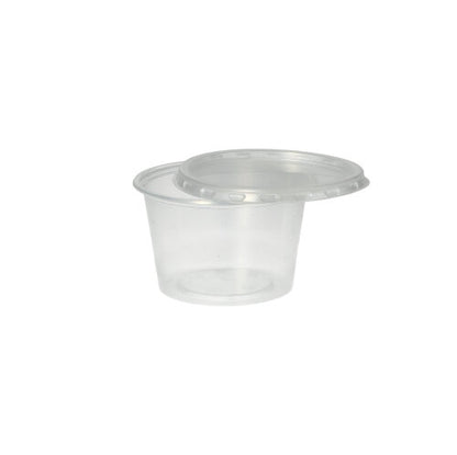 A Starpak 50 dressing cup, PP, round, Ø 7.1 cm, transparent, stands empty against a plain white background, with the matching clear plastic lid partially open on it.