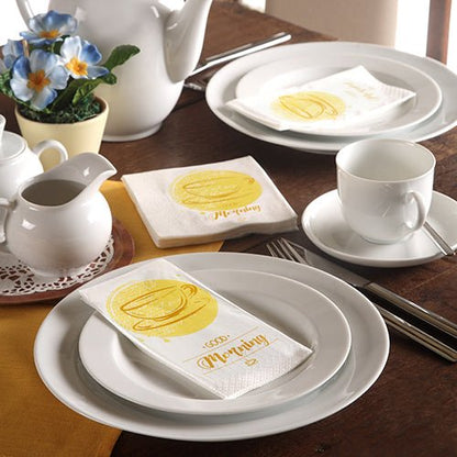A neatly set table with white tableware, a teapot, blue flowers, and 3-ply PAPSTAR-Napkins (33 x 33 cm) from the PAPSTAR GmbH with a yellow coffee mug and the word "Morning."