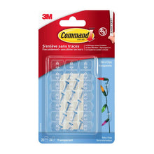 A pack of Command™ decoration clips from 3M Deutschland GmbH, transparent with clear strips, contains 20 clips and 24 adhesive strips in a clear packaging with red and blue branding.