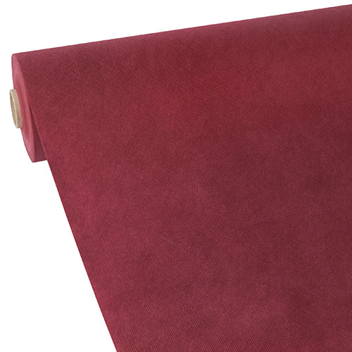 A roll of Starpak tablecloth, fabric-like, fleece “Soft Selection” by Starpak is partially rolled out at an angle on a plain white background, showing its smooth, velvety texture in deep red.