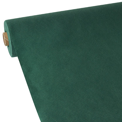 A roll of Starpak tablecloth, fabric-like, fleece “Soft Selection” in dark green is partially rolled out on a flat surface, revealing its even color and fabric-like texture. The cardboard core is visible at one end.