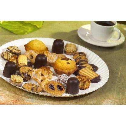 A PAPSTAR plate round Ø 32 cm, white, made of cardboard "pure" by PAPSTAR GmbH with pastries and chocolates stands next to a white coffee cup on a table. In the background, a green napkin can be seen.