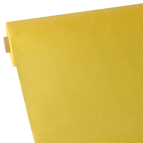 A close-up of the fabric-like fleece tablecloth "Soft Selection" from Starpak shows its yellow, fabric-like textured surface, partially rolled out against a plain white background.