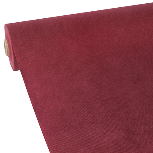 A partially rolled-out Starpak tablecloth, fabric-like fleece "Soft Selection" in deep red, is presented on a white background, revealing its smooth and slightly textured surface reminiscent of velvet or suede.