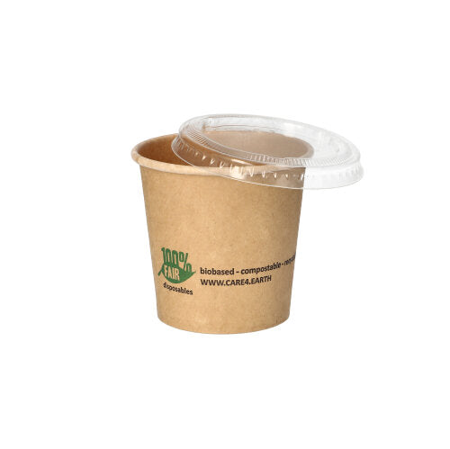 A PAPSTAR 50 portion cup made of brown cardboard from PAPSTAR GmbH with a green logo and text lies diagonally, clear plastic lid on top. Ideal as an environmentally friendly portion cup on a white background.