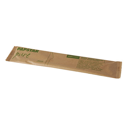 A single, unopened PAPSTAR wooden knife "pure" (16.5 cm), individually wrapped in paper and rectangular, lies on a white background. The brown paper has green text and a minimalist design. Manufacturer: PAPSTAR GmbH.