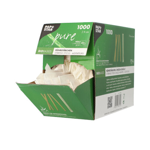 An opened green-white box with PAPSTAR 1000 wooden stir sticks, "pure", individually wrapped from PAPSTAR GmbH shows environmentally friendly, individually packaged wooden stir sticks on a white background. The box is labeled for 1000 pieces.
