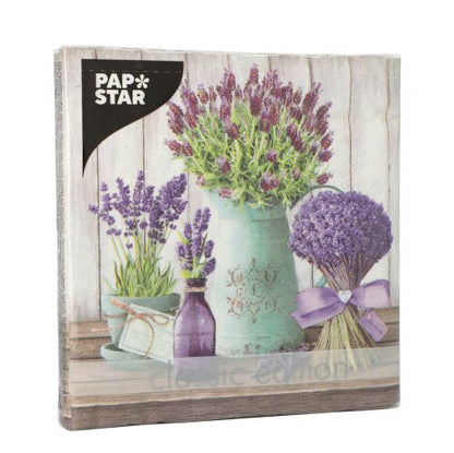 A pack of PAPSTAR 20 3-ply napkins (33x33 cm, 1/4 folded) from Design Set 3, with lavender blossoms on a wooden surface. Brand: PAPSTAR GmbH.