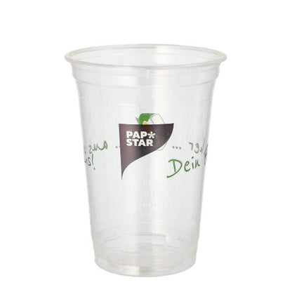A clear PAPSTAR 50 PLA drinking cup "Cup made of corn" from PAPSTAR GmbH with green and black text. Biodegradable and eco-friendly. The empty cup is depicted against a plain white background.
