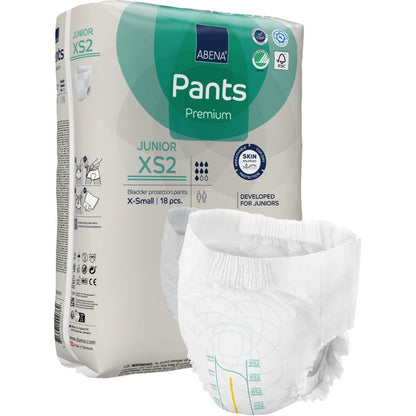 A pack of ABENA Pants Junior Premium, size XS2 from Abena Re-Seller GmbH is shown with an unfolded diaper in the foreground. The beige pack with green and blue accents contains 18 pieces of X-small.