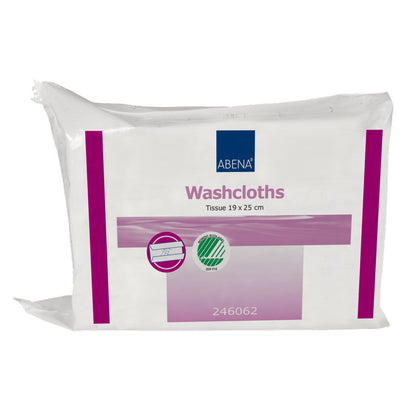 A transparent plastic packaging labeled "Abena Re-Seller GmbH Disposable Washcloths, Paper 6-layer, 19x25 cm, White" contains 125 washcloths. The front side features purple and green markings and the number 246062; the washcloths are visible inside.
