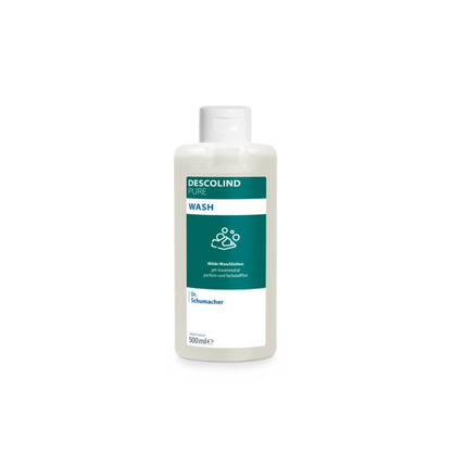 A white plastic bottle of Dr. Schumacher Descolind Pure Wash Lotion (500 ml) by Dr. Schumacher GmbH, with a green-white label, stands in front of a plain light gray background. This pH-skin-neutral perfume-free wash lotion is ideal for sensitive skin.