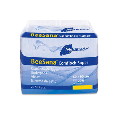 The image shows a package of Meditrade BeeSana® Comflock Super bed pads. The predominantly white package with blue accents contains 25 pads measuring 60 x 90 cm, designed for optimal care comfort. Instructions for use and product information are printed on the front.