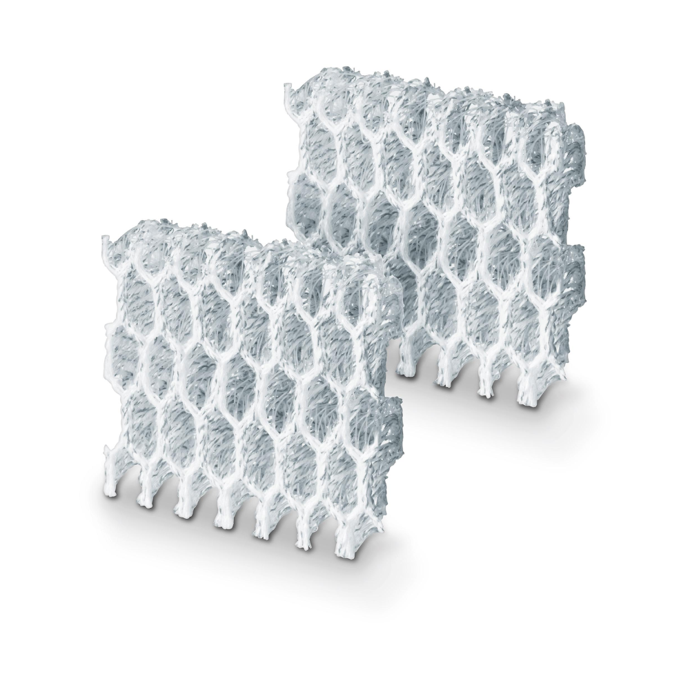 Two rectangular white foam structures with a honeycomb pattern are arranged slightly at an angle. Similar to the Beurer 2x silver ion pads for the LW 230 from Beurer GmbH, each structure has a rough texture and a grid-like design with hexagonal openings, which could be ideal for use in your air washer.