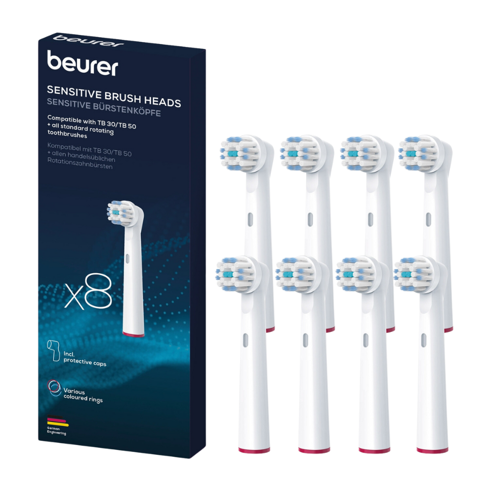 The image shows a box of Beurer Sensitive brush heads for TB 30 / TB 50 brush heads of Beurer GmbH, compatible with various rotating toothbrushes, next to eight individual brush heads. Each head is white with blue and green bristles and comes with protective caps. For your convenience, a replacement set is available.