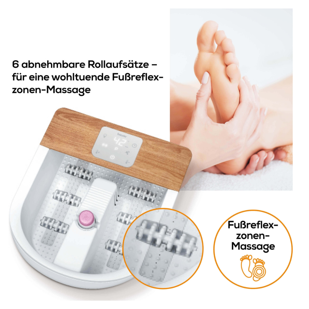 On the left is the Beurer FB 65 Wellness foot spa from Beurer GmbH with elegant wooden accents and six removable massage rollers for a soothing foot reflexology massage. On the right, a pair of hands massages a person's foot. The German text reads "6 removable rollers for a relaxing foot reflexology massage."