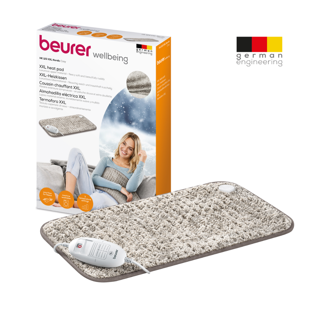 Image of a Beurer HK 123 XXL Nordic heating pad in XXL format with packaging. The textured gray heating pad features a white controller and offers 3 heat settings for customizable comfort. The packaging shows a woman using the pad, highlights product features in multiple languages, and proudly displays the logo of Beurer GmbH and 'German Engineering'.