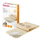 Image of a Beurer HK 45 heating pad Cosy set. The set includes a cream-colored electric heating pad with a textured surface and a connected control unit. Next to the pad is the product's packaging box with images and descriptions in multiple languages. The pad from Beurer GmbH meets the OEKO-TEX® Standard 100 certification.
