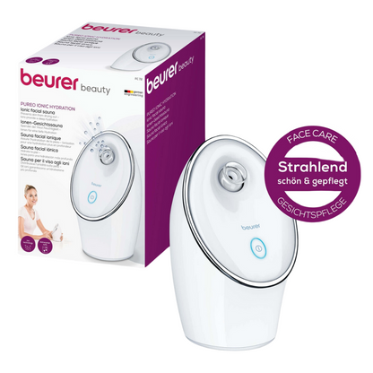 The Beurer Ion Facial Sauna FC 72 Pureo Ionic Hydration by Beurer GmbH in white with ion technology for deep-cleansing effect is depicted on the front of its packaging. The device features a round nozzle and a blue power button. The packaging highlights the product benefits in multiple languages and includes a round label with the inscription "Radiantly beautiful & well-groomed."