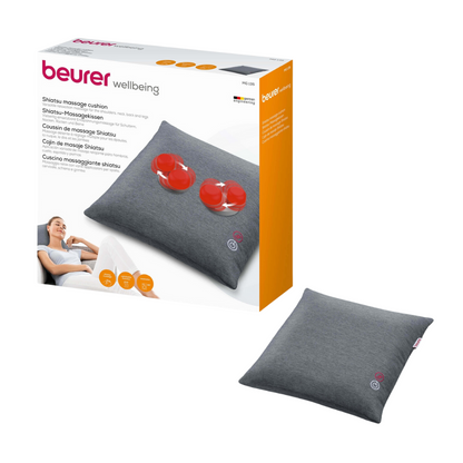 Image of the Beurer MG 135 Shiatsu massage pillow in its packaging. The packaging prominently displays the product and shows an image of the rotating massage balls and the heating function inside. The packaging, which is branded with the name „Beurer Wellbeing“ of Beurer GmbH, contains product descriptions in several languages.
