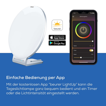 The Beurer daylight lamp TL 100 (discontinued item) from Beurer GmbH is shown in white with 10,000 lux next to a smartphone with the LightUp app, which is compatible via app store logos with iOS and Android; German text highlights the app-based control.