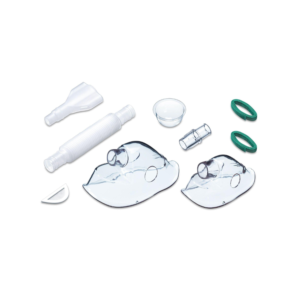 Exhibited is a collection of components for medical respiratory devices, including two transparent face masks, a flexible white corrugated hose, a small plastic cup, a T-shaped connector, and two green round seals – all compatible with the Beurer Yearpack for the IH 40 & IH 55 inhaler of Beurer GmbH.
