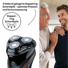 An older man with gray hair uses a Beurer HR 8000 rotary shaver from Beurer GmbH on a younger man with a beard. The shaver, equipped with a precision cutting system, features three double-ring floating heads for optimal precision and contour adaptation. The text in German describes the functions of '3 spring-loaded double-ring shaving heads'.