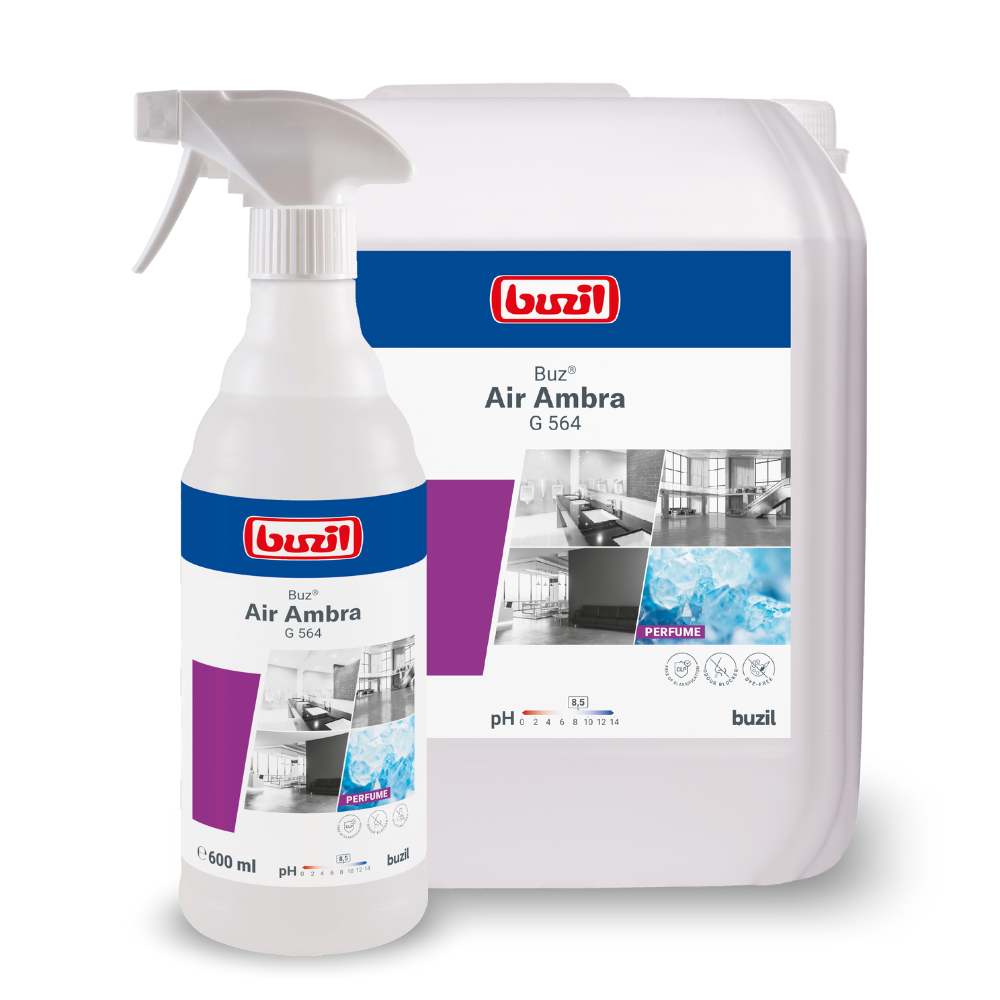 Displayed are two containers with cleaning agents: a spray bottle and a large refill can. Both bear the label "Buzil Buz® Air Ambra G 564 Ready-to-use Room Spray with Active Odor Blocker" from BUZIL-WERK Wagner GmbH & Co. KG, featuring clean rooms and water, as well as an active odor blocker for long-lasting freshness.