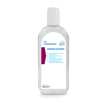 A transparent 500 ml bottle of Dr. Schumacher GmbH ORANGE SOLVENT instrument cleaner with a white cap and blue-white label, for adhesive removal and instrument cleaning, depicted against a white background.