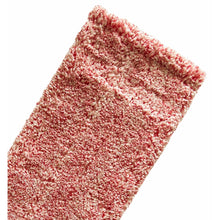 Close-up of a pink and white, textured, rectangular fabric - obviously the Arcora MICRO RED DB - FC towel from Arcora International GmbH - against a white background.