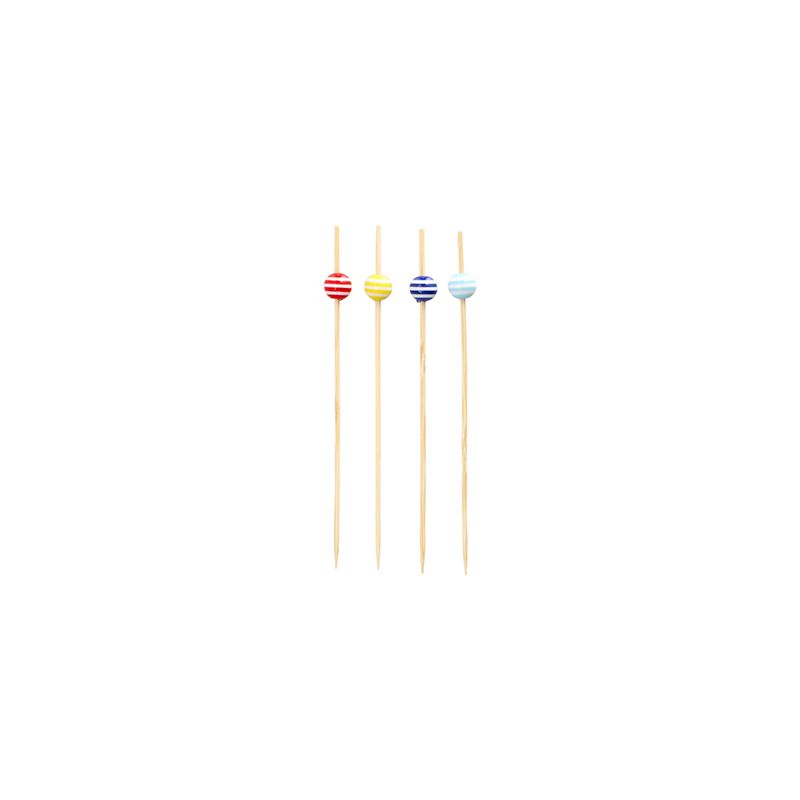 Four 12 cm large PAPSTAR finger food skewers, each decorated with a striped bead in red, yellow, blue, and light blue, are arranged in a row. The stylish products of PAPSTAR GmbH are made as sustainable disposable products and rest elegantly on a simple white background.
