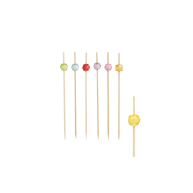 Six colorful PAPSTAR finger food picks, each with a different color tip – blue, green, red, pink, orange, and yellow – are arranged vertically against a flawlessly white background. Another skewer with a yellow tip is on the right, highlighting PAPSTAR GmbH's commitment to sustainable disposable products.