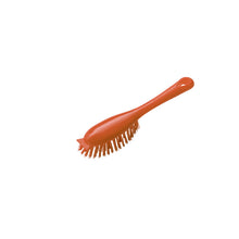 The HANDLE BRUSH WITH SHORT HANDLE PBT from Haug Bürsten KG is a red plastic cleaning brush with stiff PBT bristles and a short handle, standing on a plain white background.