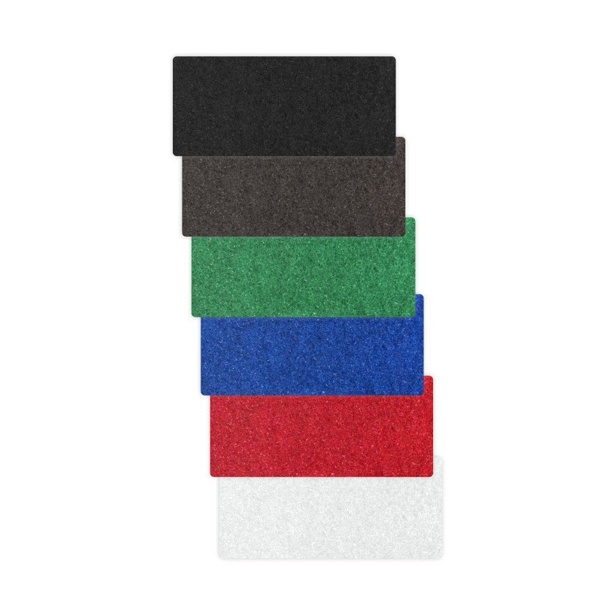 Six Arcora HANDPAD - THICK 250 x 15 cm mats from Arcora International GmbH are stacked vertically in the colors black, brown, green, blue, red, and white - ideal as a hand pad or cleaning tool for polishing metal.