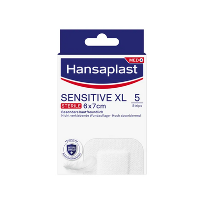 The image shows a pack of Hansaplast Sensitive XL, sterile, particularly skin-friendly, sterile wound strips from Beiersdorf AG, perfect for effective wound care. The pack contains 5 strips measuring 6 cm x 7 cm. The packaging emphasizes the skin-friendly and non-stick properties of the product with high absorbency.