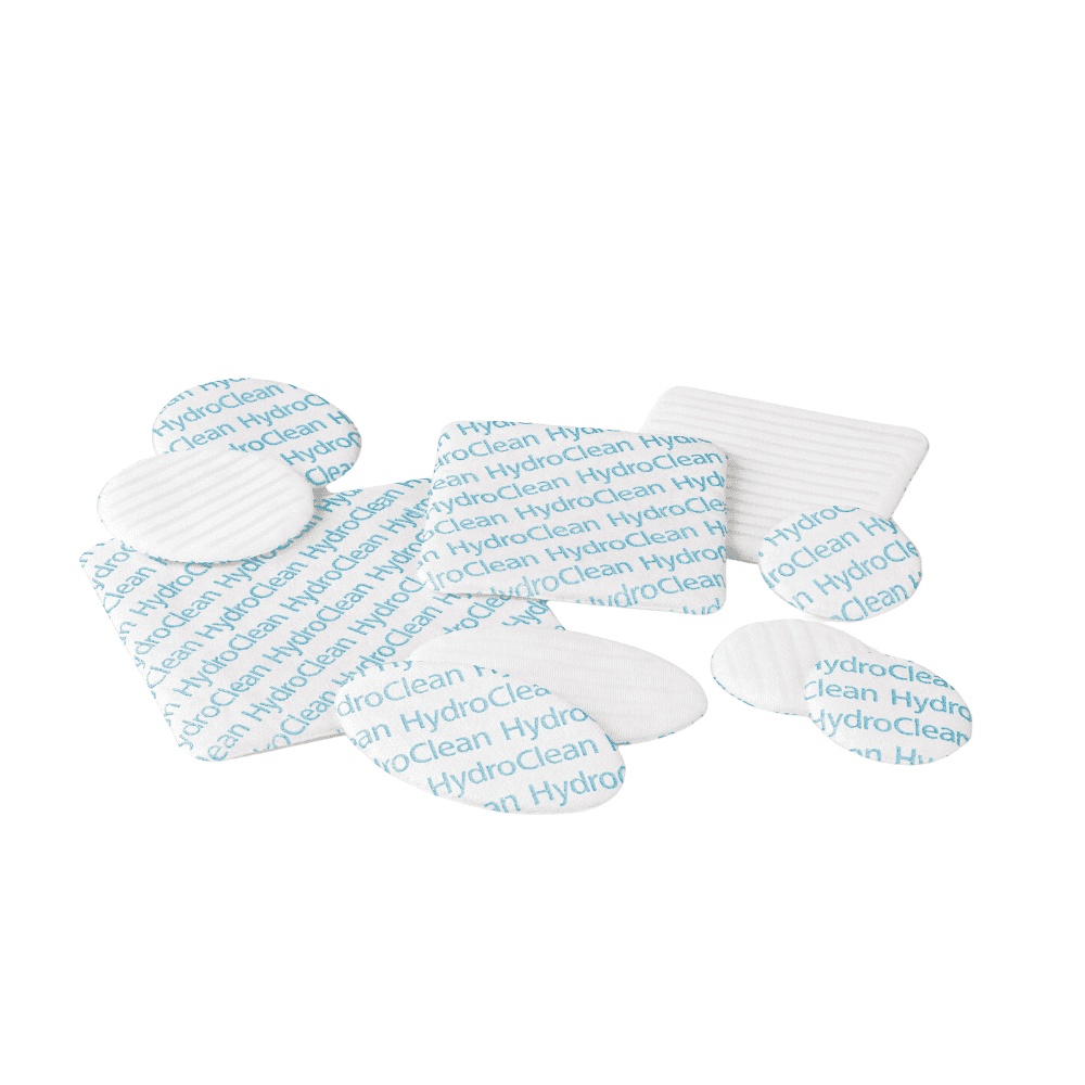 A collection of four white and blue Hartmann HydroClean® wound dressings from Paul Hartmann AG, arranged on a white background.