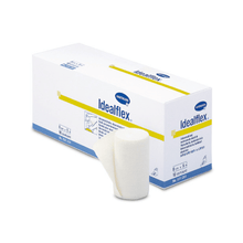 A box of Idealflex® light universal bandages from Paul Hartmann AG, with one roll partially unpacked at the front, highlighting the texture and shape of the product. The packaging is white and blue with text and brand details.