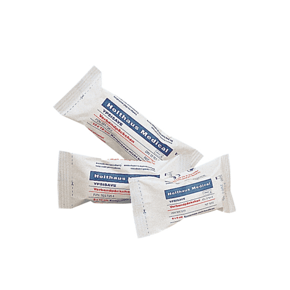 Displayed are three packages of Holthaus Medical YPSISAVE sterile bandage packs, each with blue and red lettering. The text on the packaging is presumably in German and contains product information. Each package is individually wrapped and sealed, indicating that these are sterile bandage packs from Holthaus Medical GmbH & Co. KG.