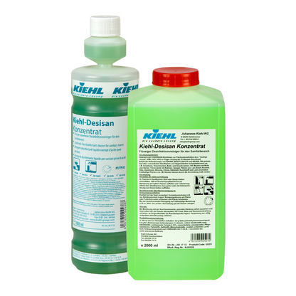 Two bottles of Kiehl Desisan Concentrate Liquid acid-free disinfectant cleaner from Johannes Kiehl KG: a tall, transparent one with a white cap/blue label; a rectangular, green one with a red cap/white label - ideal for hygienic cleaning.