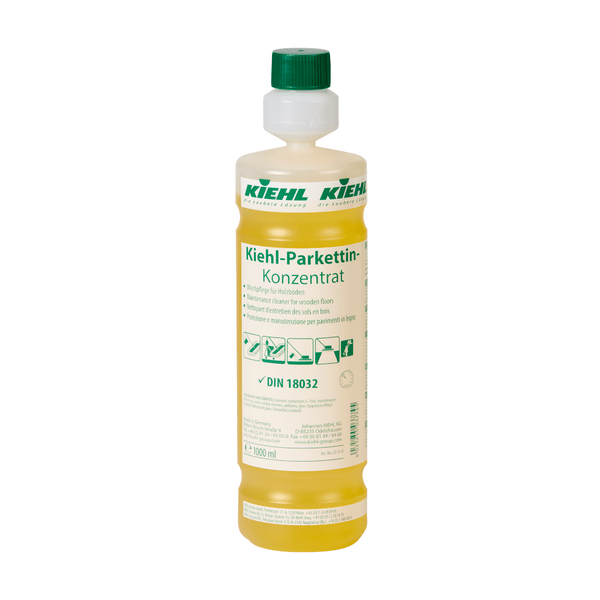 A transparent plastic bottle with yellow liquid labeled "Kiehl Parkettin Concentrate Floor Care for Wooden Floors" by Johannes Kiehl KG, with green and white branding and application instructions on the label.