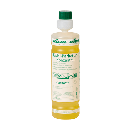 A transparent plastic bottle with yellow liquid labeled "Kiehl Parkettin Concentrate Floor Care for Wooden Floors" by Johannes Kiehl KG, with green and white branding and application instructions on the label.