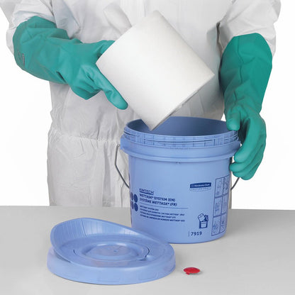A person in a white-green protective suit places a white roll of Kimberly-Clark GmbH WypAll® Wettask™ wipes (6 refills x 90 sheets, White) into a blue bucket.