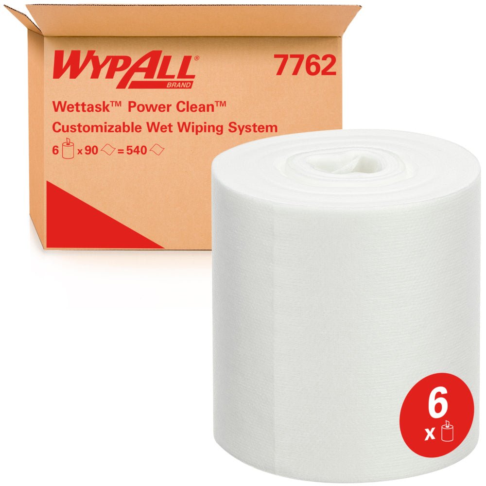 A large roll of WypAll® Wettask™ wipes from Kimberly-Clark GmbH stands in front of a box labeled "6 rolls x 90 sheets / carton", referring to six absorbent refill rolls.