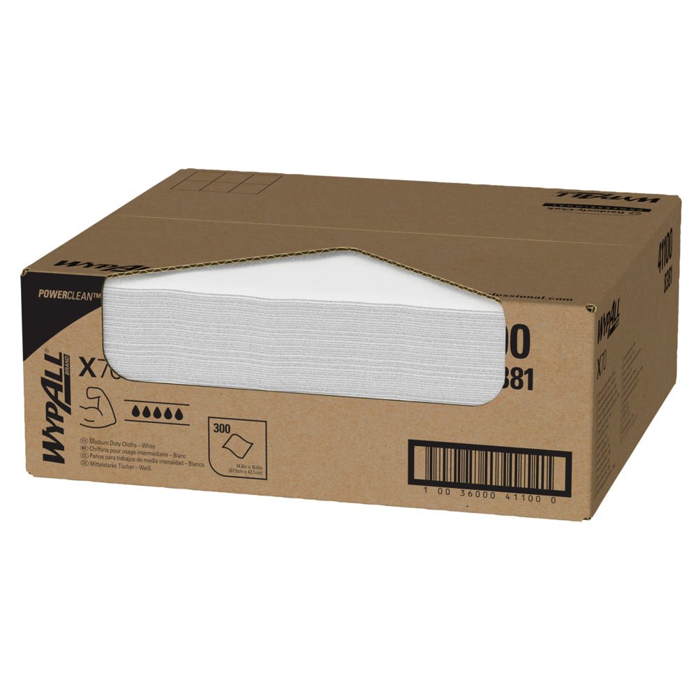 A brown carton labeled "WypAll® X70 PowerClean" from Kimberly-Clark GmbH contains 300 white towels for industrial cleaning, visible through a side opening. Barcode and product details are printed on the carton.