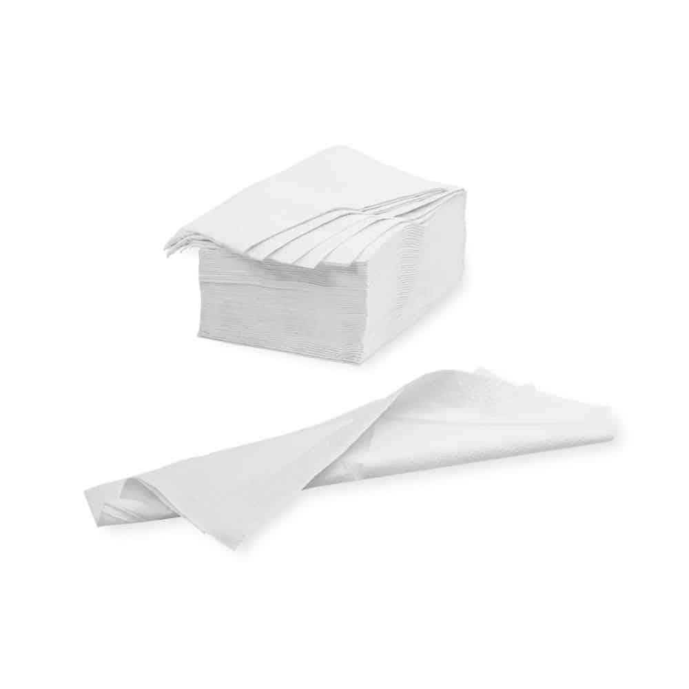 A stack of folded white Meditrade wipes - 39 x 30 cm | Carton (20 packs) from Meditrade GmbH is seen against a plain white background. A napkin is unfolded and lies in front of the stack, showing its full size and emphasizing its high-quality cellulose composition.