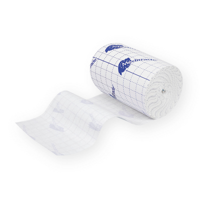 A roll of white medical adhesive tape with the inscription “Meditrade ABE® fixing fleece, self-adhesive”, partially unrolled. The tape, designed for sensitive skin, features a grid pattern and blue printed logos and is perfect for dressing fixation.