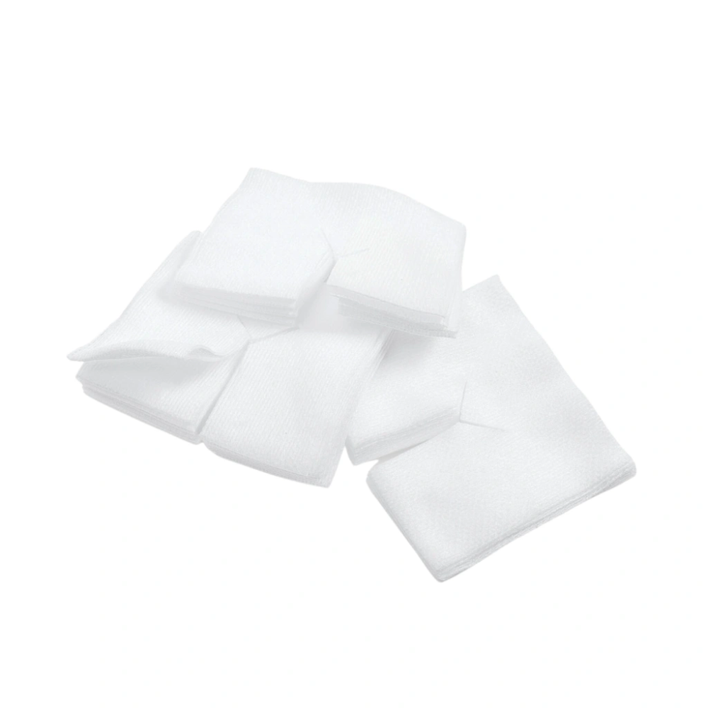 A group of neatly stacked, small white fabric squares labeled as BeeSana® Vliesschlitzkompresse 6-ply 10 x 10 cm | Package (50 pieces) by Meditrade GmbH, is arranged against a white background. The fabric appears folded and of uniform size, ideal for wound care.
